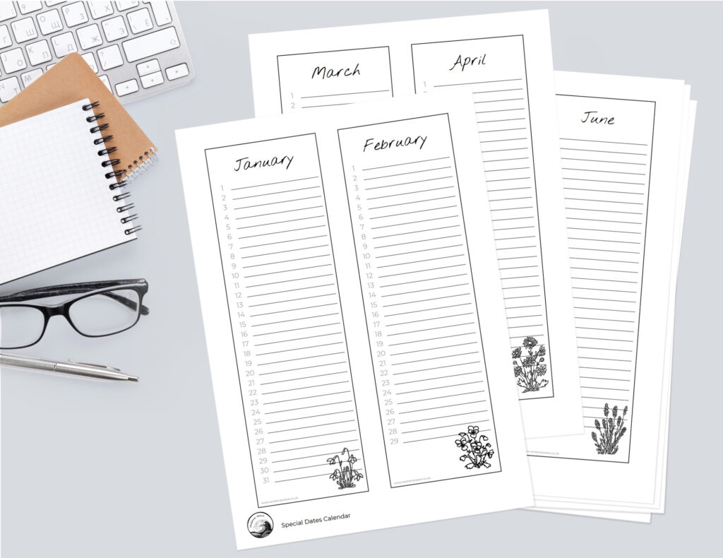 Flay lay image showing the Special Dates Calendar pages. On the left side of the image is part of a computer keyboard, note books, reading glasses and a pen.