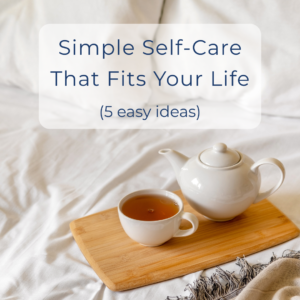 Photo of a teapot and cup of tea on a tray in an unmade bed.