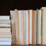 Image of books on a bookshelf, spines facing away.